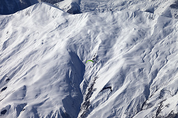 Image showing Off-piste slope and paraglider in nice day