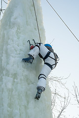 Image showing Girl climbs upward on ice climbing competition