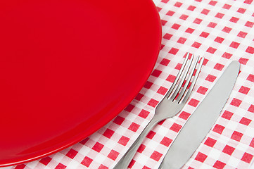 Image showing Red plate and cutlery