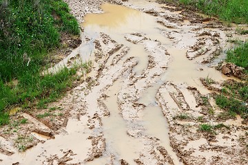 Image showing Car ruts in dirty road mud 