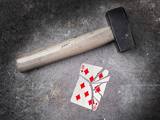 Image showing Hammer with a broken card, eight of diamonds