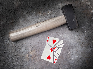 Image showing Hammer with a broken card, three of hearts