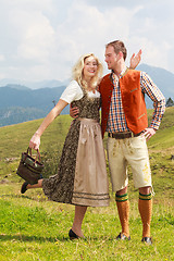 Image showing Bavarian couple in fashionable leather pants and dirndl