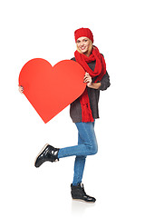 Image showing Full length girl holding up a red cardboard heart