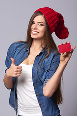 Image showing Smiling woman holding credit card