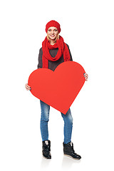 Image showing Full length girl holding up a red cardboard heart