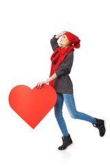 Image showing Full length girl holding up a red cardboard heart