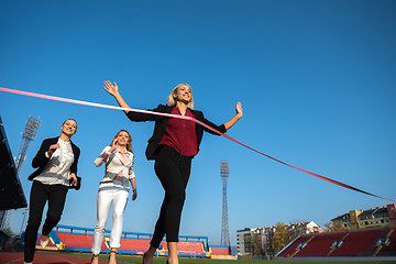 Image showing business people running on racing track