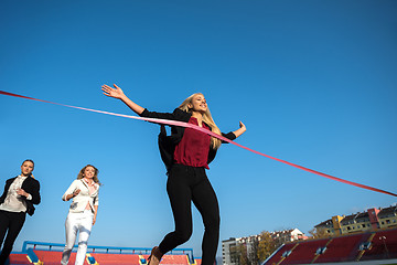 Image showing business people running on racing track