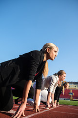 Image showing business people running on racing track