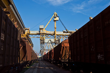 Image showing Grain from silos being loaded onto cargo ship on conveyor belt