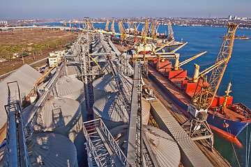 Image showing Grain from silos being loaded onto cargo ship on conveyor belt
