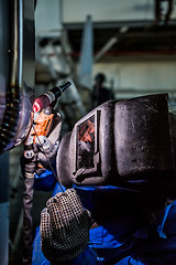 Image showing Man welding with reflection of sparks on visor. Hard job. 