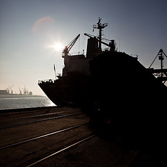 Image showing Grain from silos being loaded onto cargo ship on conveyor belt