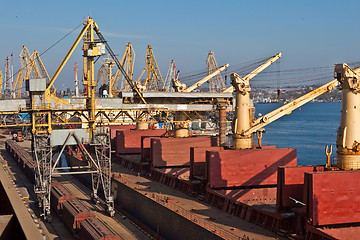 Image showing Grain from silos being loaded onto cargo ship on conveyor belt