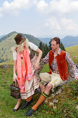 Image showing Couple flirting in the Bavarian costumes