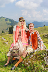 Image showing Lovers pants in fashionable traditional Bavarian Dirndl and leather with hat