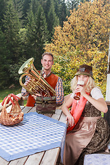 Image showing Young couple in traditional Bavarian clothes enjoy your leisure in common