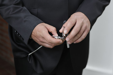 Image showing Groom looks at the clock