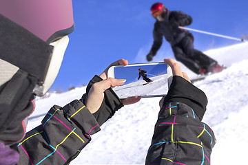 Image showing Photographed skiers with mobile phone