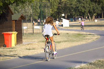 Image showing Woman riding a bicycle