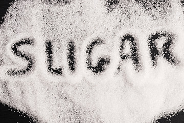 Image showing The word sugar written into a pile of white granulated sugar