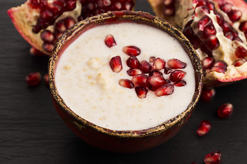 Image showing Dish of banana millet breakfast pudding with pomegranate