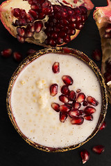 Image showing Dish of banana millet breakfast pudding with pomegranate