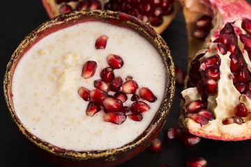 Image showing Dish of banana millet breakfast pudding with pomegranate