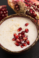 Image showing Dish of banana millet breakfast pudding with pomegranate