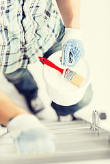 Image showing man with paintbrush, pot and ladder