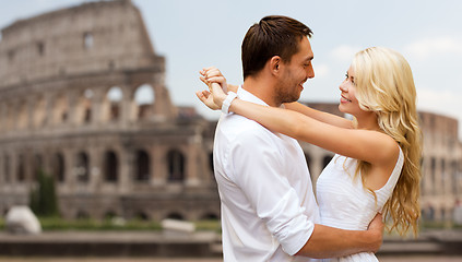 Image showing happy couple hugging over coliseum