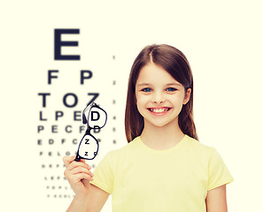 Image showing smiling cute little girl holding black eyeglasses