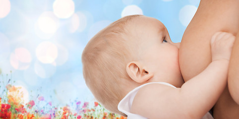 Image showing close up of mother breast feeding adorable baby