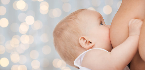 Image showing close up of mother breast feeding adorable baby