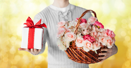 Image showing man holding basket full of flowers and gift box