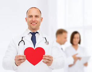 Image showing smiling male doctor with red heart and stethoscope