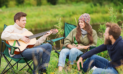 Image showing group of tourists playing guitar in camping