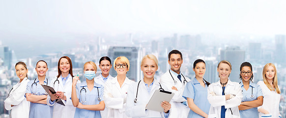 Image showing smiling female doctors and nurses with tablet pc