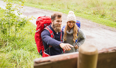 Image showing smiling couple with backpacks hiking