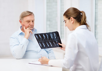 Image showing female doctor with old man looking at x-ray