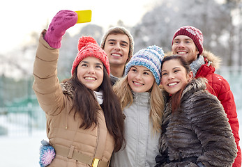 Image showing happy friends taking selfie with smartphone