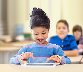 Image showing little school girl with tablet pc over classroom