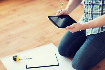 Image showing male with tablet pc, blueprint and measuring tape