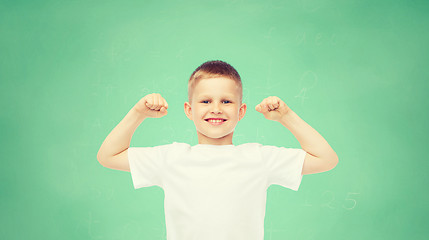 Image showing happy little boy in white t-shirt flexing biceps