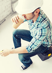 Image showing builder drinking take away coffee