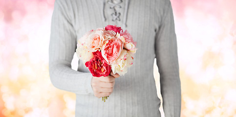 Image showing close up of man holding flowers