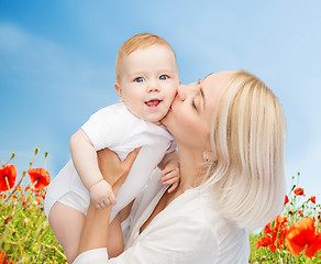 Image showing happy mother with baby over natural background
