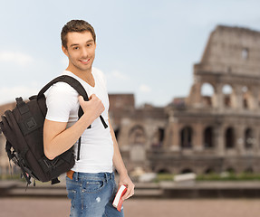 Image showing happy young man with backpack and book travelling