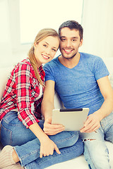 Image showing smiling happy couple with tablet pc at home